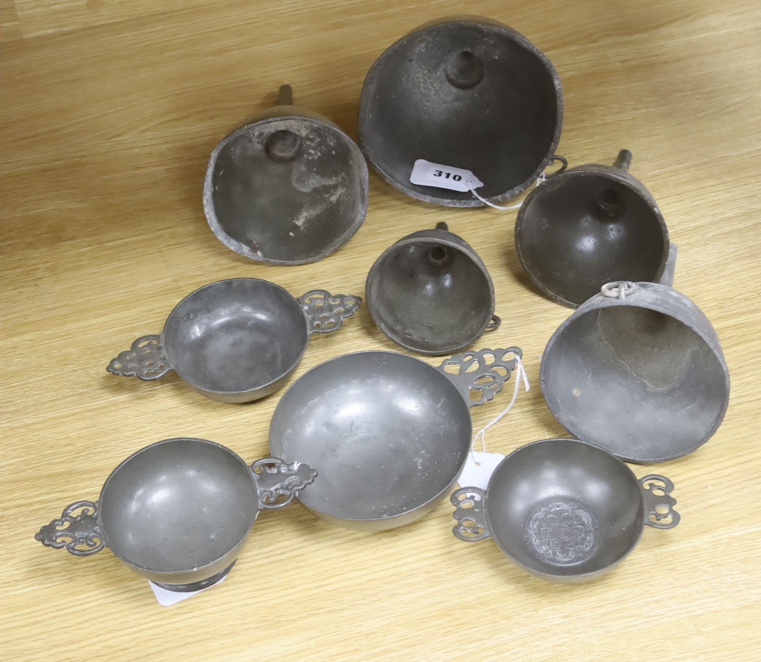 Nine items of 18th and 19th century pewter, including three quaich, a blood letting type bowl and five wine funnels, widest 15cm